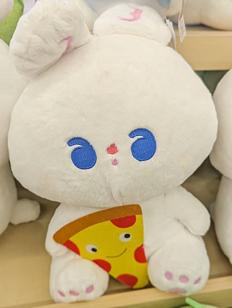 istock A cute white bunny plush toy holding a pizza slice. 2231232454