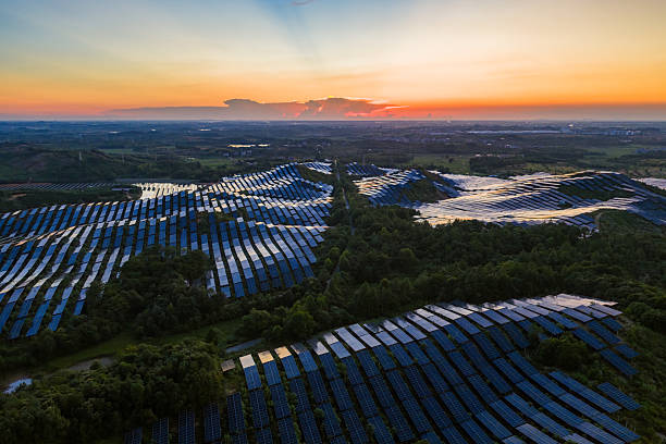 istock Solar photovoltaic panels on a hillside at sunset 2231233133