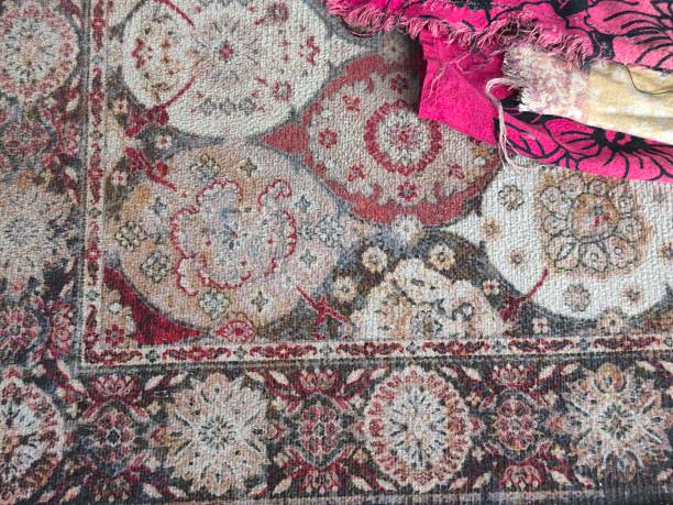 istock Intricate Patterns on a Traditional Rug with a Vibrant Pink Fabric Detail. 2231234400
