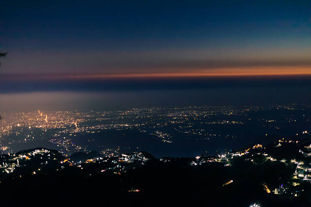 istock City Lights Twinkling Below from a Mountain Viewpoint at Night 2231239622