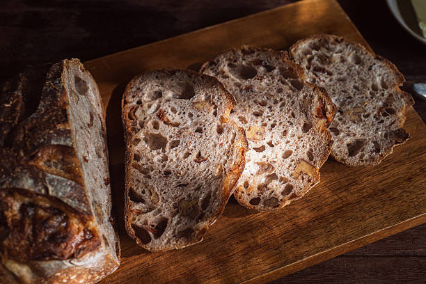 istock cranberry walnuts sourdough bread sliced placed on wooden cutting board. 2231240547