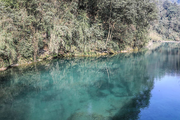 A beautiful blue river under the snow-capped mountains