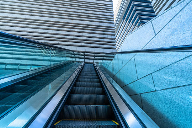 istock Escalator and modern office buildings in downtown. 2231248139
