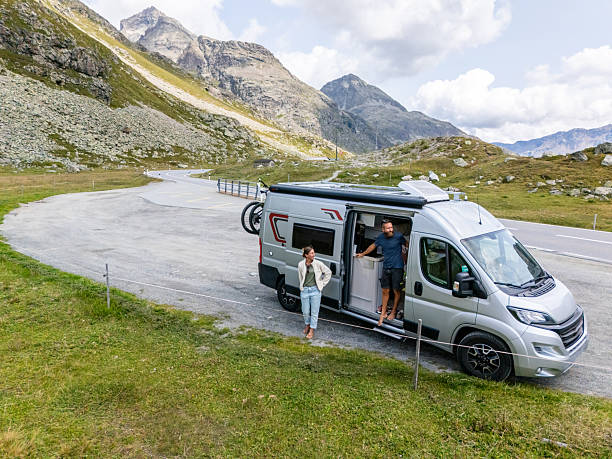 Couple Enjoying Mountain Road Trip in Campervan