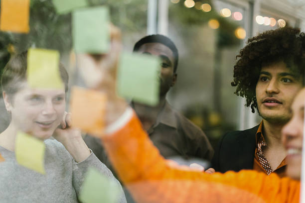 istock Business team brainstorming and planning using sticky notes on glass wall 2231255413