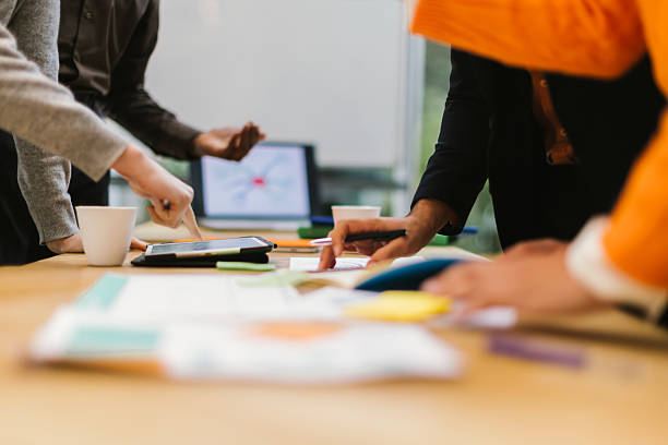 istock Business people working together using digital tablet and documents during meeting 2231255442