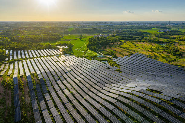istock Solar photovoltaic panels on a hillside at sunset 2231257297
