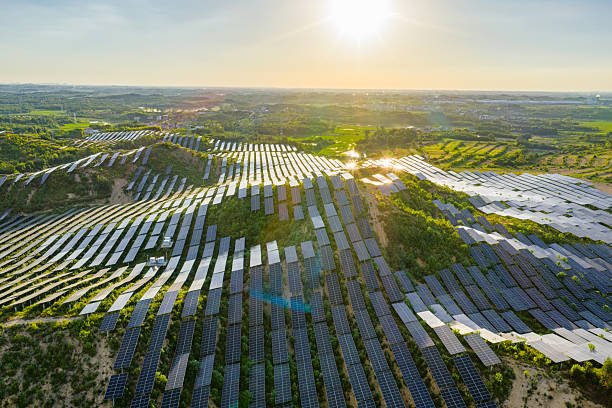 istock Solar photovoltaic panels on a hillside at sunset 2231257348