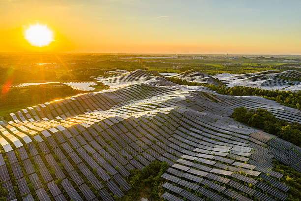 istock Solar photovoltaic panels on a hillside at sunset 2231257664