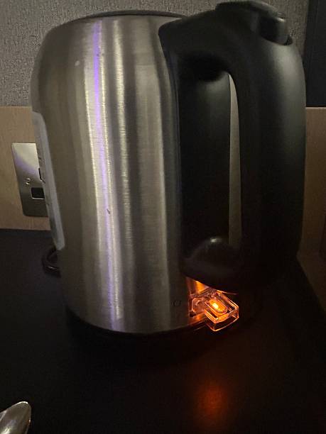 istock Modern Stainless Steel Electric Kettle with Illuminated Power Indicator on a Countertop 2231271448