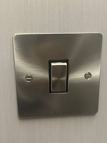 istock Close-Up of a Modern Metal Light Switch on a Wall 2231271457