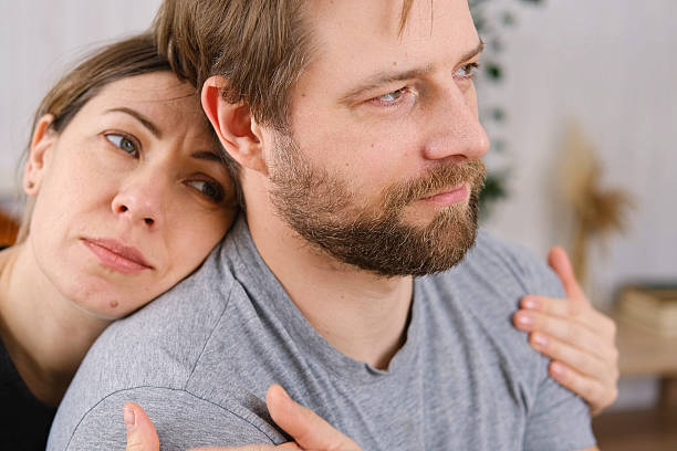 istock Loving mature couple interactions at home. Husband and wife hugging, holding hands and drinking morning coffee together. Man and woman talk about plans for weekend. Natural lighting. Intimate moments. 2231277458
