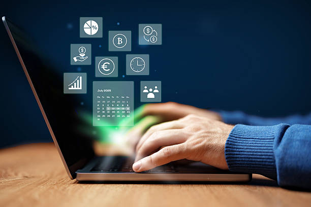 istock Hands typing on laptop with digital financial icons and data analytics displayed on screen in a modern workspace 2231280343
