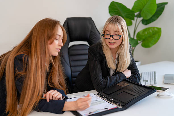 istock Colleagues collaborating on a project in a modern office setting during the afternoon, discussing notes and planning strategies 2231281287
