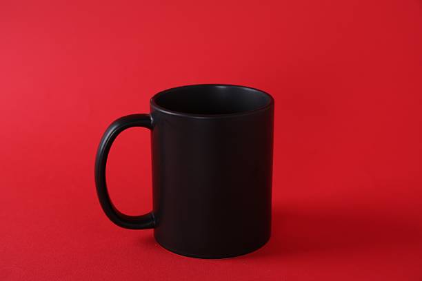 istock One blank black mug on red background. Mockup for design 2231282020