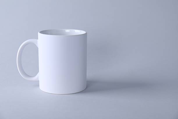 istock One blank white mug on light background. Mockup for design 2231282052