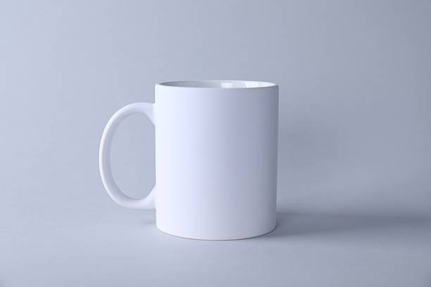 istock One blank white mug on light background. Mockup for design 2231282118