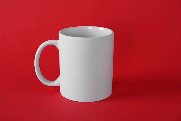 istock One blank white mug on red background. Mockup for design 2231282535