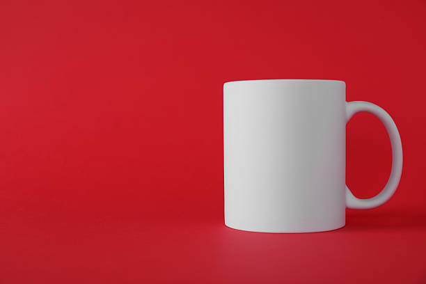 istock One blank white mug on red background. Mockup for design 2231282555
