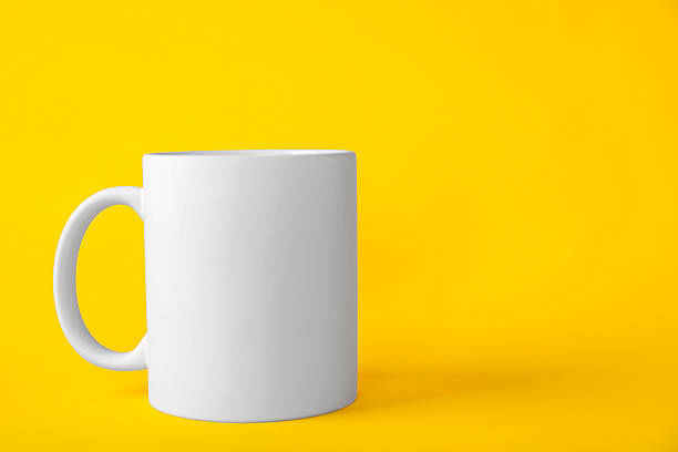 istock One blank white mug on yellow background. Mockup for design 2231282798