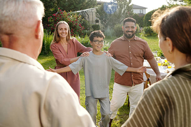 istock Multiethnic Family Gathering Outdoors Smiling and Embracing Each Other 2231283943