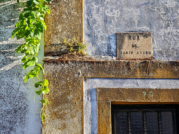 istock Weathered wall and sign on Rua de Santo Amaro, Castelo de Vide 2231284384