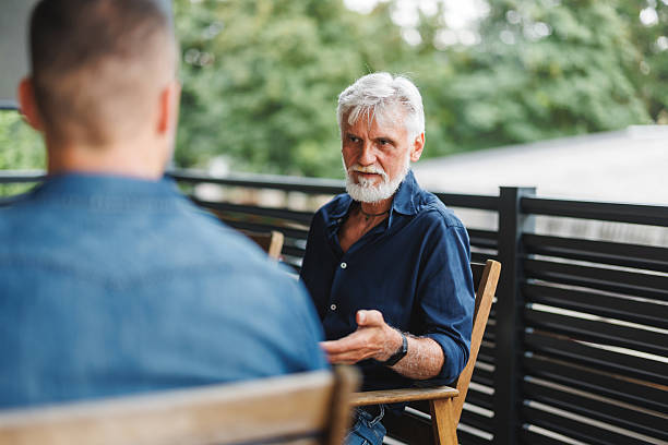 istock Father And Son Bonding Conversation Outdoors 2231285641