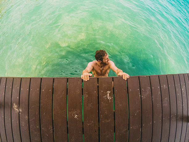 Young man swims in the sea