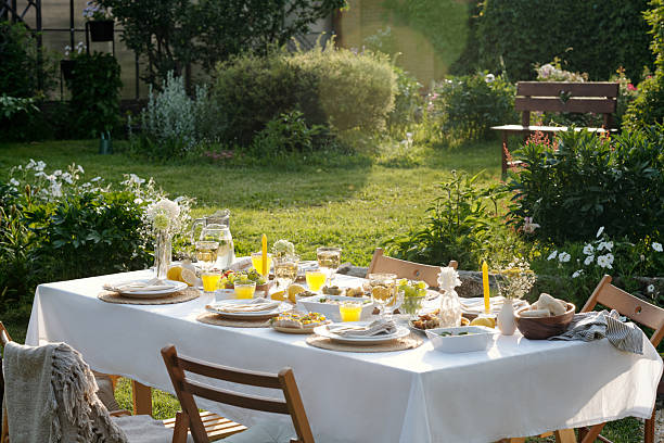 istock Sunlit Outdoor Garden Table Arranged for Relaxing Summer Brunch Gathering 2231288403