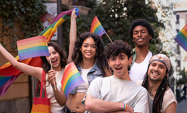 istock Young activists celebrating with rainbow flags at pride parade 2231289122