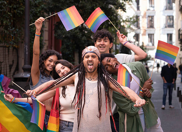 istock Young activists holding rainbow flags celebrating gay pride 2231289205