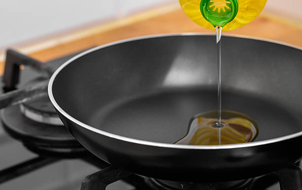 istock Pour rapeseed oil into the pan for frying 2231290936