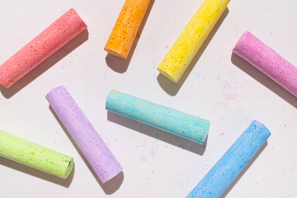 istock Multicolored bright crayons for drawing on light gray background flat lay top view. Children's chalk close-up. Concept of creativity, child development, back to school 2231291157