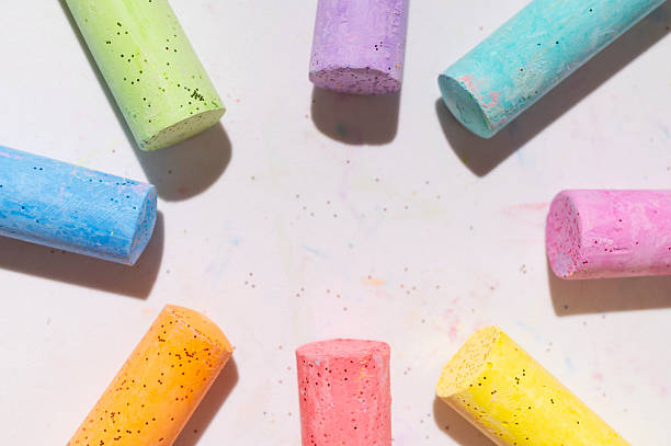 istock Multicolored bright crayons for drawing on light gray background flat lay top view. Children's chalk close-up. Concept of creativity, child development, back to school 2231291160