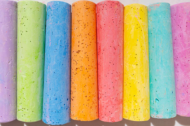 istock Multicolored bright crayons for drawing on light gray background flat lay top view. Children's chalk close-up. Concept of creativity, child development, back to school 2231291162