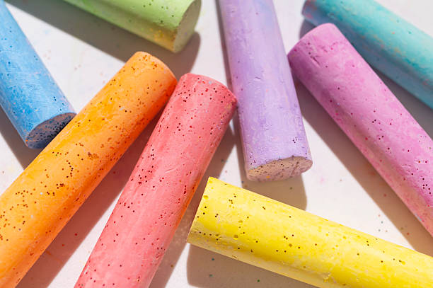 istock Multicolored bright crayons for drawing on light gray background flat lay top view. Children's chalk close-up. Concept of creativity, child development, back to school 2231291165