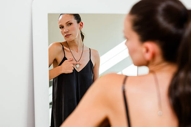istock Female reflection in mirror with high-tech necklace 2231292052