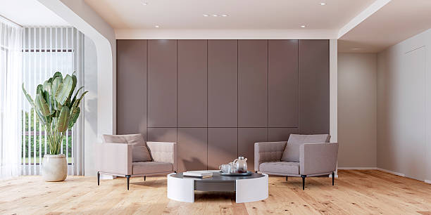 istock Modern office interior : a sleek and modern lounge area interior with a table and two soft textile armchairs, high brown cabinets, potted plant, with high windows, on hardwood floor 2231292643