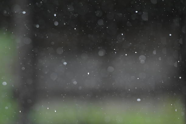 Raindrops falling from the roof of a house