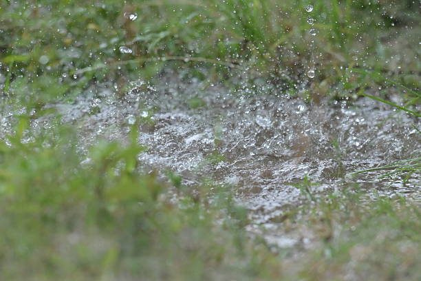 Raindrops falling from the roof of a house