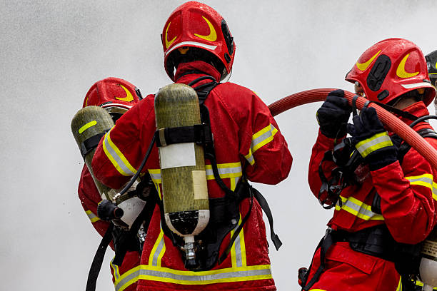 Portraits of a female firefighter in her uniform in a rural and industrial area.