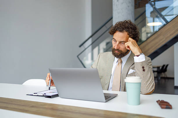 istock Businessman feeling stressed while working on laptop in office 2231296406