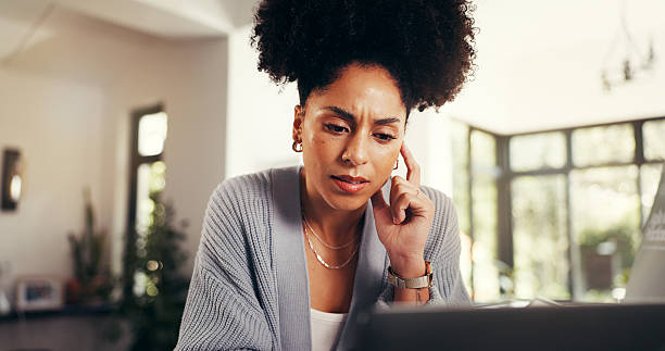 istock Confused, thinking and woman with laptop, home or proofreading article with mistake on web or online. Remote work, journalist and African person with stress for project, reflection and worry in house 2231299840