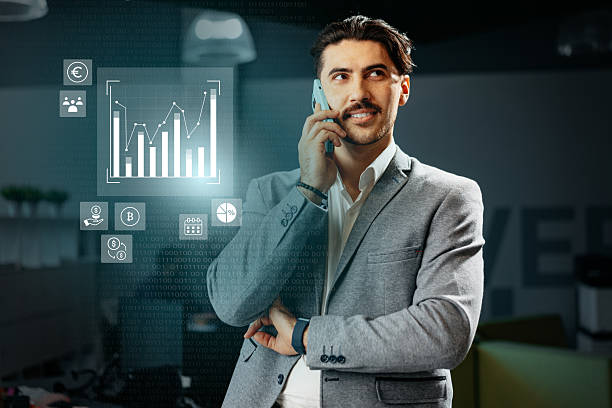 istock Business professional engaging in a phone call while analyzing digital data in a modern office environment 2231300487