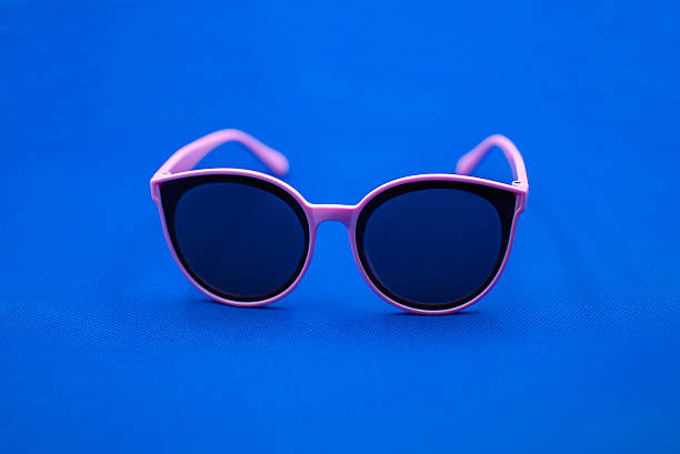 istock Pink sunglasses on blue background 2231301869