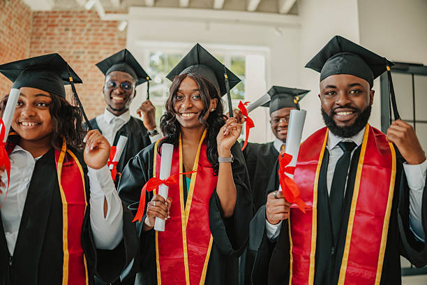 istock Graduates celebrate success together while holding diplomas inside a university building filled with joy and friendship 2231304222