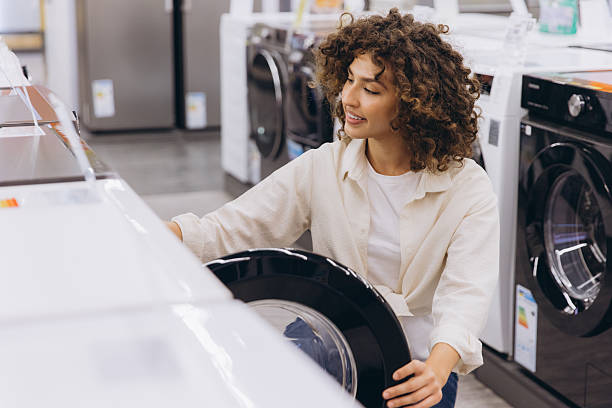 istock Woman choosing washing machine in appliances store 2231305257