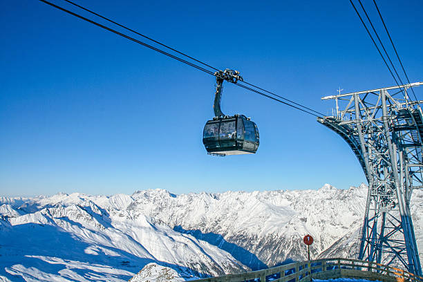 istock Cable car in snowy alpine mountains with clear blue sky. 2231306652
