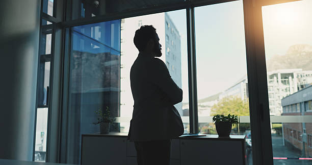 istock Thinking, window and businessman in office for proposal ideas, finance planning and problem solving. Corporate, consultant and back of worker with professional view, solution and decision for vision 2231306665