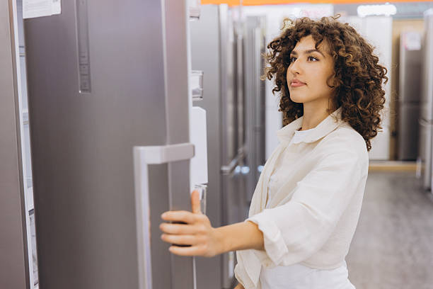 istock Woman Choosing Refrigerator in Electronics Store 2231306886